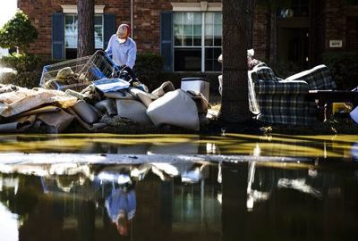 Sept. 7, 2017: homeowner Sohail Soomro dumps flood damage debris on his front yard in the aftermath of Hurricane Harvey at the Canyon Gate community in Katy, Te
