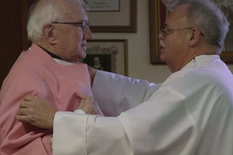 Newtown’s Father Bod Weiss and Dunblane’s Monsignor Basil O’Sullivan embrace on the first anniversary of Newtown School Shooting.
